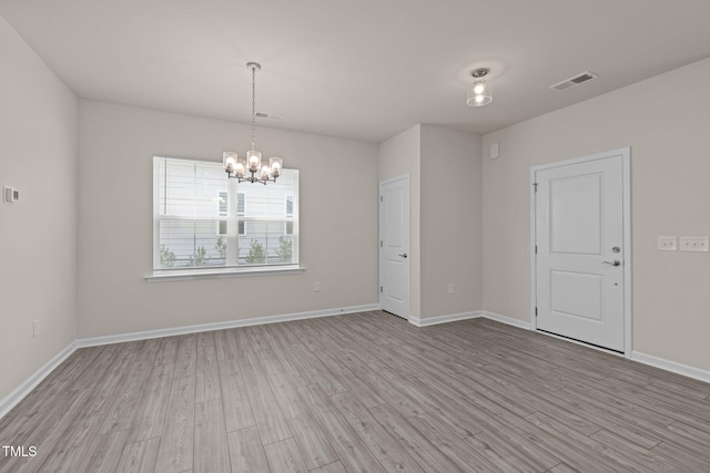 348 Abbots Mill Dr, Raleigh, NC 27603 - empty room with a chandelier and light wood-style floors