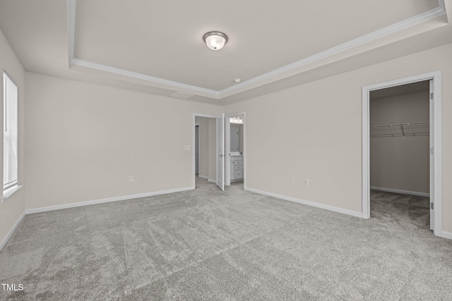 348 Abbots Mill Dr, Raleigh, NC 27603 - unfurnished bedroom with a raised ceiling, ornamental molding, carpet flooring, a walk in closet, and ensuite bath