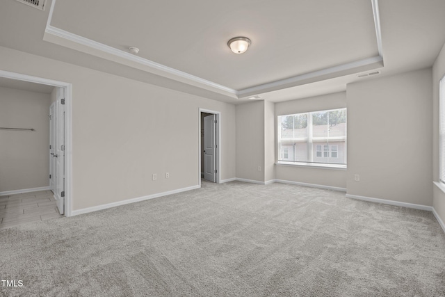 348 Abbots Mill Dr, Raleigh, NC 27603 - unfurnished bedroom with a raised ceiling, carpet, and crown molding