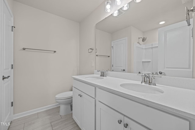 348 Abbots Mill Dr, Raleigh, NC 27603 - full bath featuring double vanity, wood finish floors, and recessed lighting