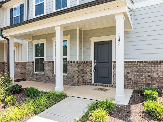 348 Abbots Mill Dr, Raleigh, NC 27603 - view of exterior entry with covered porch and brick siding