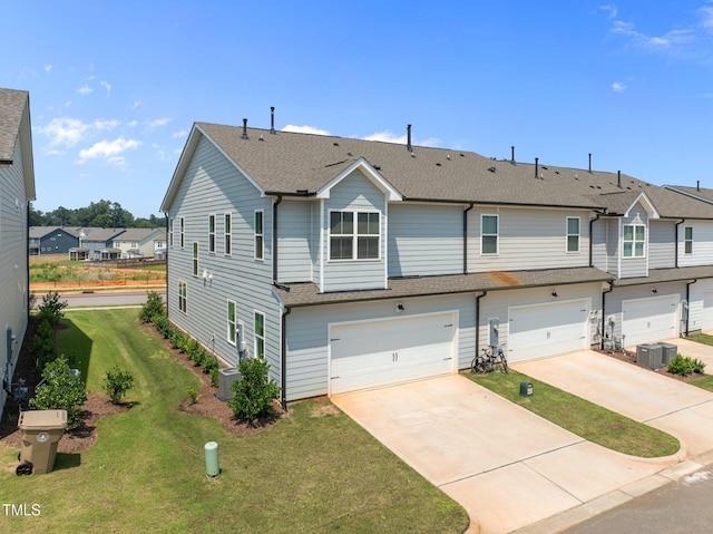 348 Abbots Mill Dr, Raleigh, NC 27603 - view of front of property featuring a garage, driveway, roof with shingles, and a front lawn