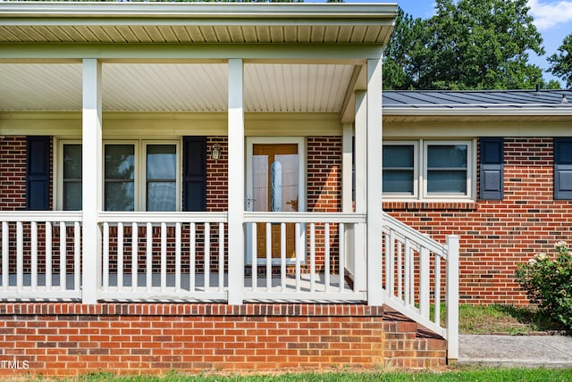 7060 Dirgie Mine Rd, Roxboro, NC 27574 - view of exterior entry with brick siding and a porch