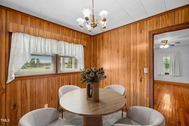 7060 Dirgie Mine Rd, Roxboro, NC 27574 - dining area featuring wooden walls, a chandelier, and light wood-style flooring