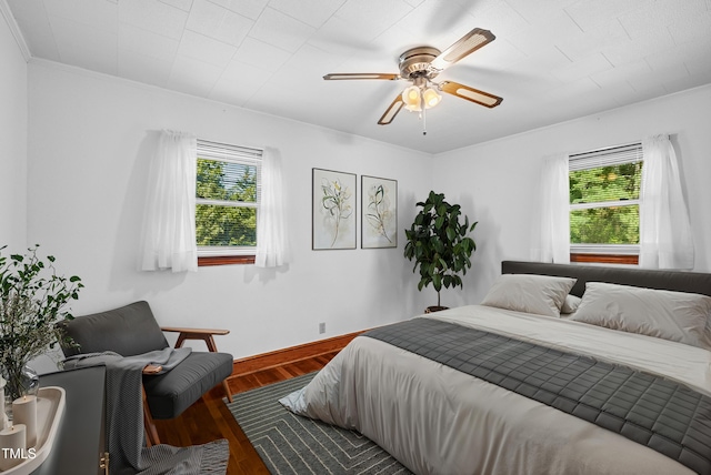 7060 Dirgie Mine Rd, Roxboro, NC 27574 - bedroom featuring multiple windows, wood finished floors, a ceiling fan, and ornamental molding