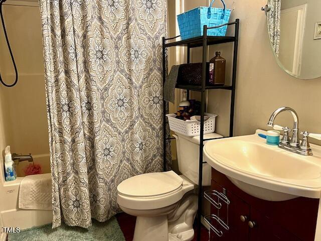 174 Daffodil Dr, Henderson, NC 27537 - bathroom featuring vanity and shower / bathtub combination with curtain