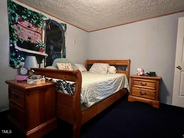 174 Daffodil Dr, Henderson, NC 27537 - bedroom with a textured ceiling and crown molding