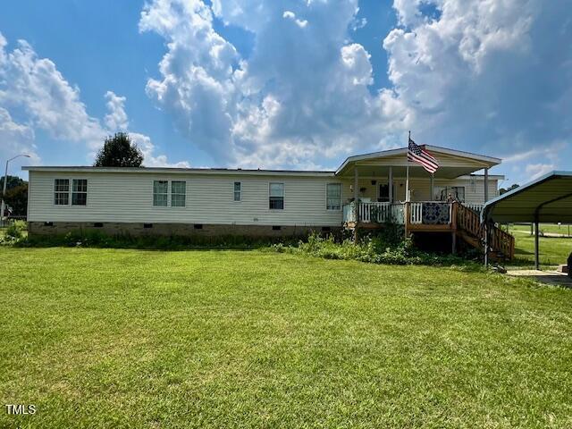 174 Daffodil Dr, Henderson, NC 27537 - rear view of house featuring crawl space, a yard, and covered porch