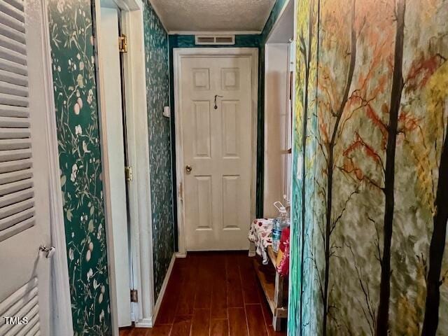 174 Daffodil Dr, Henderson, NC 27537 - entryway featuring a textured ceiling and dark wood-style floors