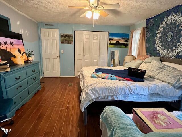 174 Daffodil Dr, Henderson, NC 27537 - bedroom featuring a textured ceiling, wood finished floors, a ceiling fan, and a closet