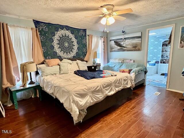 174 Daffodil Dr, Henderson, NC 27537 - bedroom featuring a textured ceiling, wood finished floors, and ceiling fan
