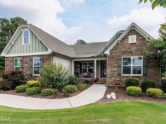 8712 Halsey Ln, Wake Forest, NC 27587 - craftsman inspired home featuring stone siding, a porch, a front lawn, board and batten siding, and roof with shingles