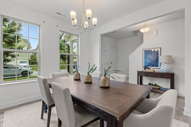 837 Stable Fern Dr, Fuquay Varina, NC 27526 - dining area with light wood finished floors and a chandelier