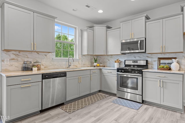 837 Stable Fern Dr, Fuquay Varina, NC 27526 - kitchen with stainless steel appliances, tasteful backsplash, gray cabinetry, and recessed lighting