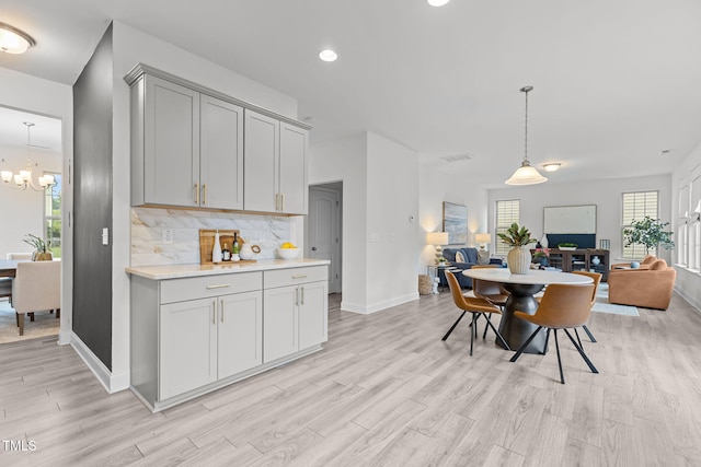 837 Stable Fern Dr, Fuquay Varina, NC 27526 - dining space with light wood finished floors, a chandelier, plenty of natural light, and recessed lighting