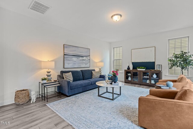 837 Stable Fern Dr, Fuquay Varina, NC 27526 - living area featuring wood finished floors and healthy amount of natural light