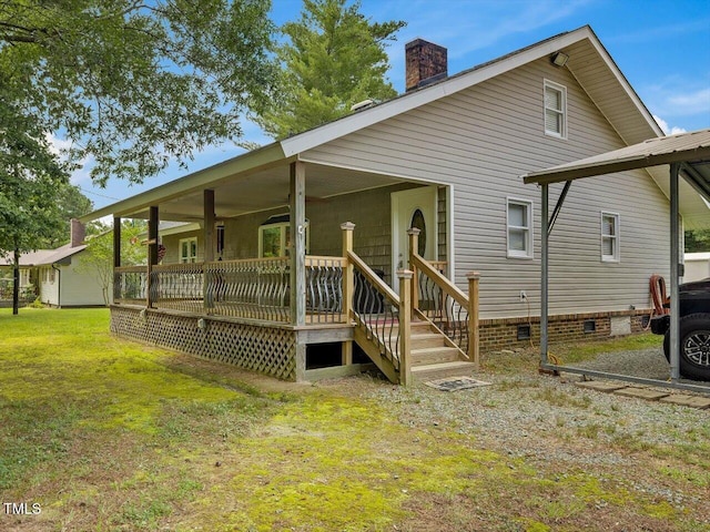 358 Benjie Williams Rd, Staley, NC 27355 - back of property with a chimney, crawl space, covered porch, and a lawn