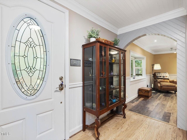 358 Benjie Williams Rd, Staley, NC 27355 - foyer featuring wood finished floors, arched walkways, crown molding, and wainscoting