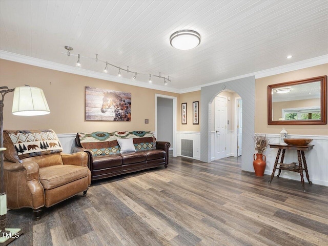 358 Benjie Williams Rd, Staley, NC 27355 - living room featuring arched walkways, crown molding, wood finished floors, wainscoting, and track lighting
