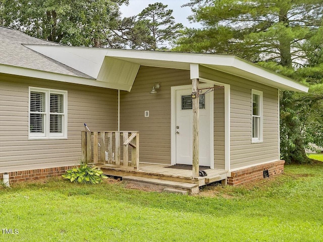 358 Benjie Williams Rd, Staley, NC 27355 - view of exterior entry featuring a shingled roof, crawl space, and a yard
