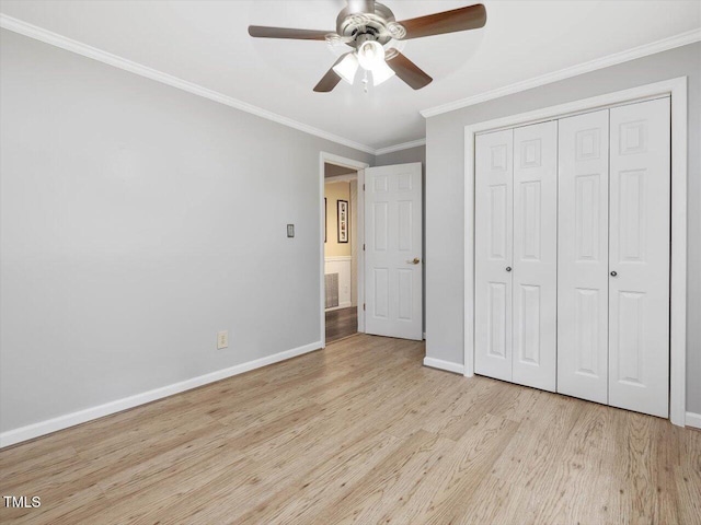 358 Benjie Williams Rd, Staley, NC 27355 - unfurnished bedroom featuring wood finished floors, crown molding, a closet, and a ceiling fan