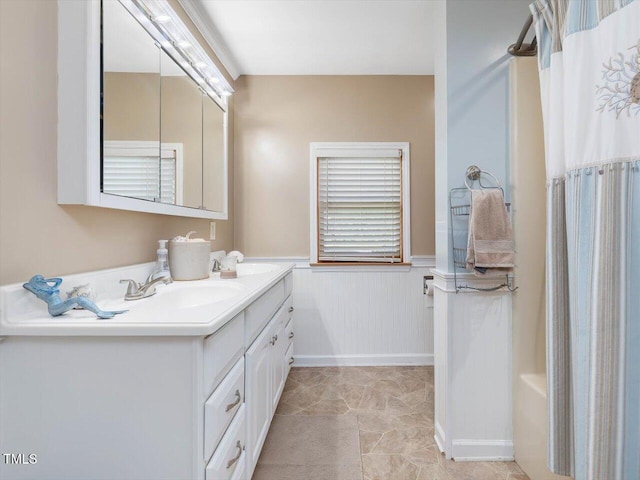 358 Benjie Williams Rd, Staley, NC 27355 - full bath featuring double vanity, wainscoting, and shower / bath combination with curtain
