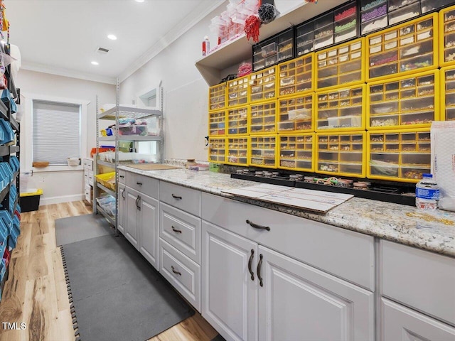 358 Benjie Williams Rd, Staley, NC 27355 - kitchen with ornamental molding, white cabinets, light wood-style floors, light countertops, and recessed lighting