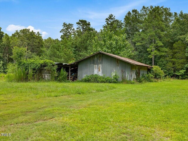 358 Benjie Williams Rd, Staley, NC 27355 - view of home's exterior with a view of trees, a yard, and an outdoor structure