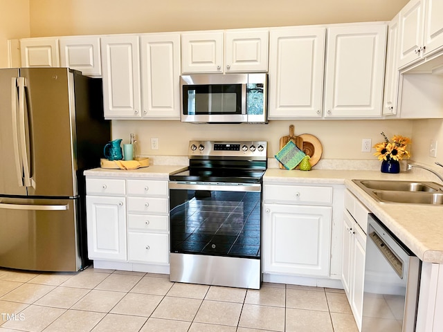 2520 Friedland Pl Unit 200, Raleigh, NC 27617 - kitchen with stainless steel appliances, white cabinetry, light countertops, and light tile patterned flooring