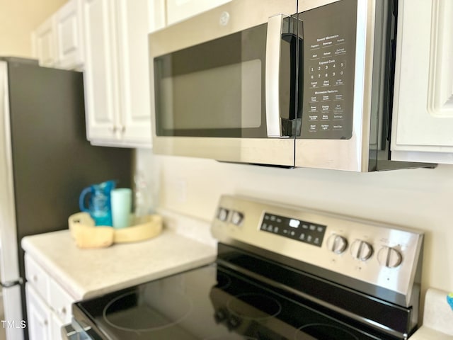 2520 Friedland Pl Unit 200, Raleigh, NC 27617 - kitchen view of appliances with stainless steel finishes, white cabinets, and light countertops