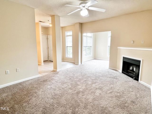 2520 Friedland Pl Unit 200, Raleigh, NC 27617 - unfurnished living room with ceiling fan, carpet, a fireplace, and a textured ceiling
