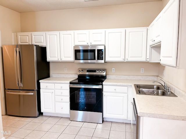 2520 Friedland Pl Unit 200, Raleigh, NC 27617 - kitchen with appliances with stainless steel finishes, light tile patterned flooring, white cabinetry, and light countertops