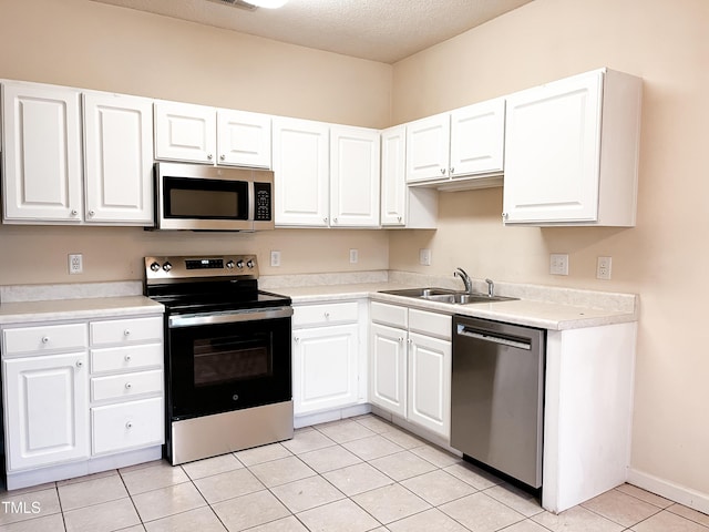 2520 Friedland Pl Unit 200, Raleigh, NC 27617 - kitchen featuring stainless steel appliances, white cabinets, light tile patterned flooring, light countertops, and a textured ceiling