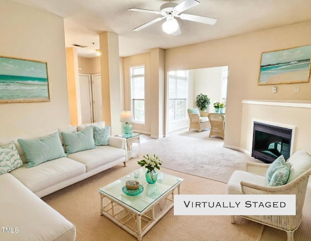 2520 Friedland Pl Unit 200, Raleigh, NC 27617 - carpeted living room featuring a glass covered fireplace and ceiling fan