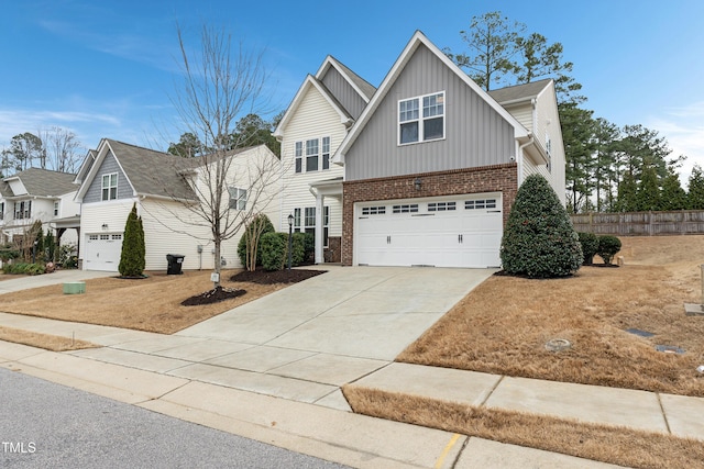 165 Naples Ln, Clayton, NC 27527 - view of front of house featuring an attached garage, board and batten siding, concrete driveway, and brick siding