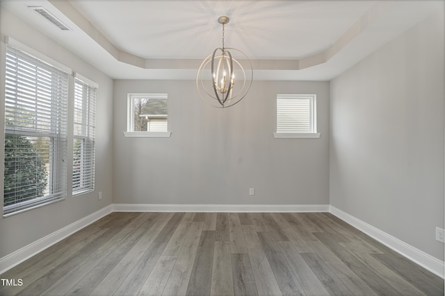165 Naples Ln, Clayton, NC 27527 - unfurnished room featuring a chandelier, a raised ceiling, and wood finished floors