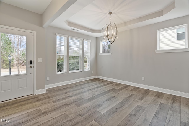 165 Naples Ln, Clayton, NC 27527 - entryway featuring a chandelier, a tray ceiling, and wood finished floors