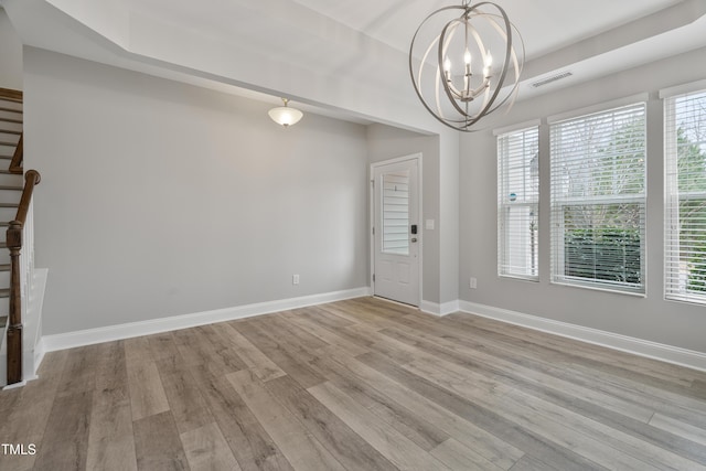 165 Naples Ln, Clayton, NC 27527 - unfurnished dining area featuring stairway, light wood finished floors, a chandelier, and plenty of natural light