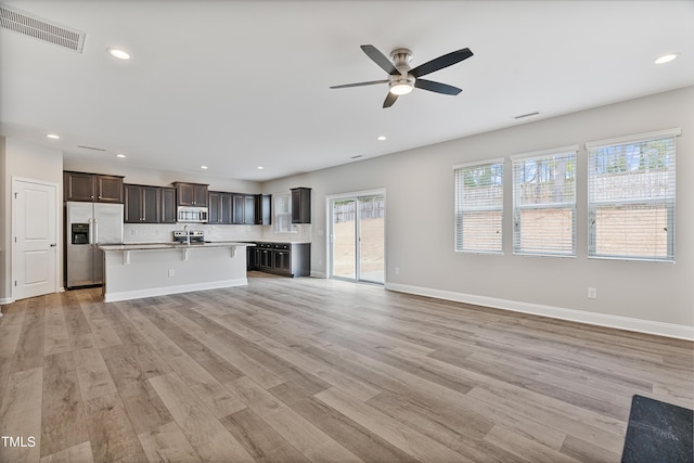165 Naples Ln, Clayton, NC 27527 - unfurnished living room featuring a ceiling fan, light wood-style flooring, and recessed lighting