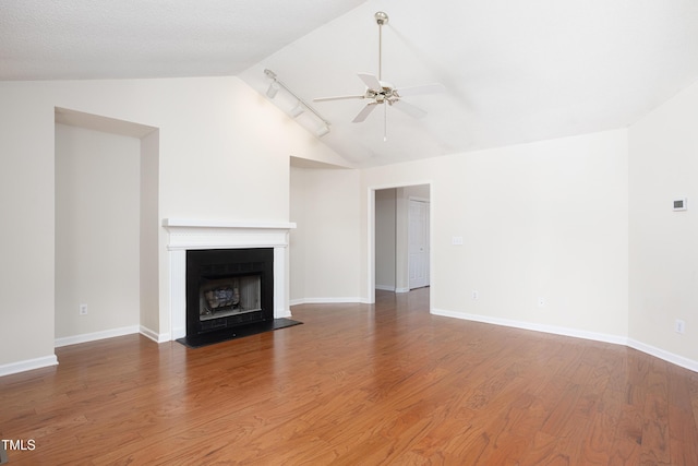 3213 Planet Dr, Raleigh, NC 27604 - unfurnished living room with vaulted ceiling, a ceiling fan, a fireplace with flush hearth, and wood finished floors
