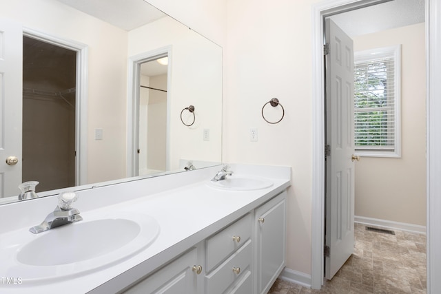 3213 Planet Dr, Raleigh, NC 27604 - bathroom featuring double vanity and stone finish flooring