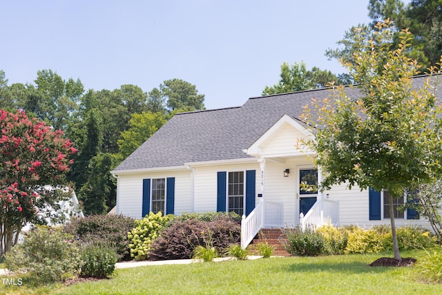 3213 Planet Dr, Raleigh, NC 27604 - view of front of house with a front yard and a shingled roof