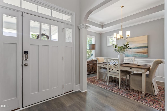 630 Heartland Flyer Dr, Knightdale, NC 27545 - entrance foyer featuring dark wood-style flooring, arched walkways, ornamental molding, a chandelier, and decorative columns