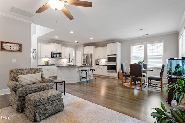 630 Heartland Flyer Dr, Knightdale, NC 27545 - living room featuring crown molding, dark wood-style floors, ceiling fan, and recessed lighting