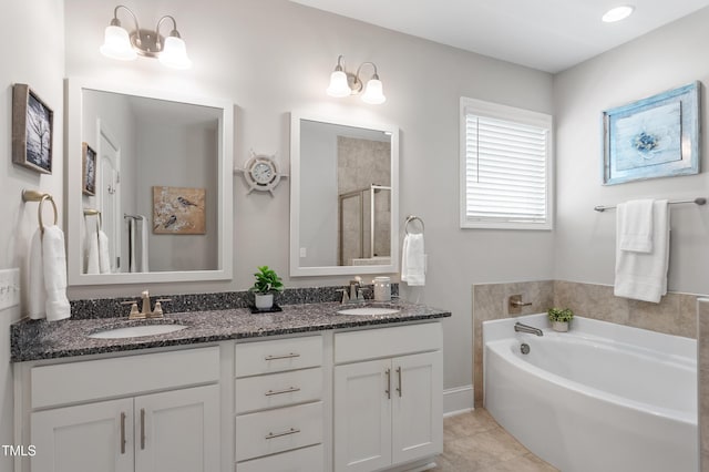 630 Heartland Flyer Dr, Knightdale, NC 27545 - full bathroom with a shower stall, a garden tub, double vanity, and tile patterned flooring