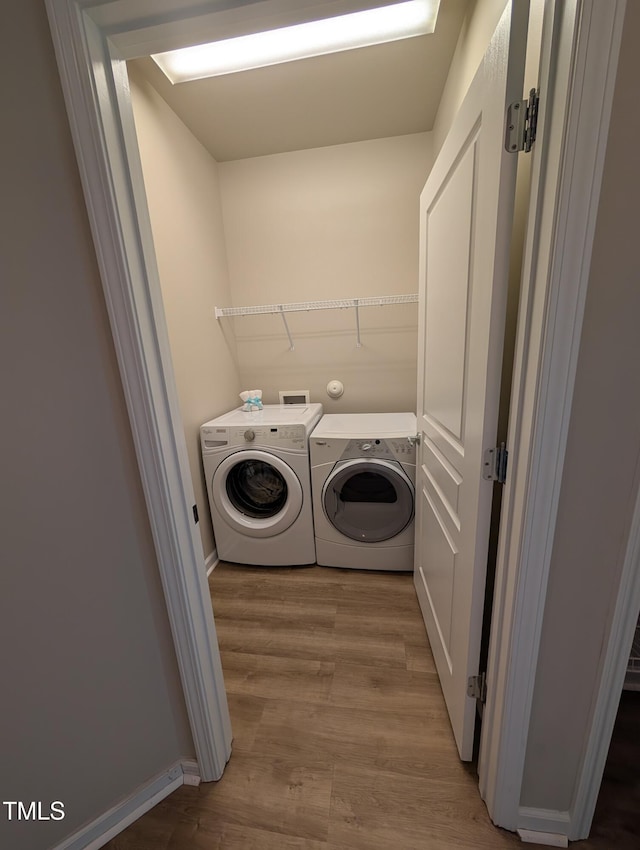 4221 Del Webb Ave, Cary, NC 27519 - washroom featuring separate washer and dryer and wood finished floors