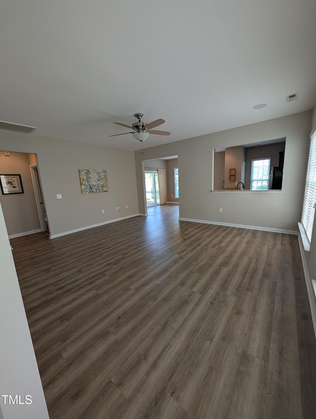 4221 Del Webb Ave, Cary, NC 27519 - unfurnished living room with dark wood-type flooring and ceiling fan