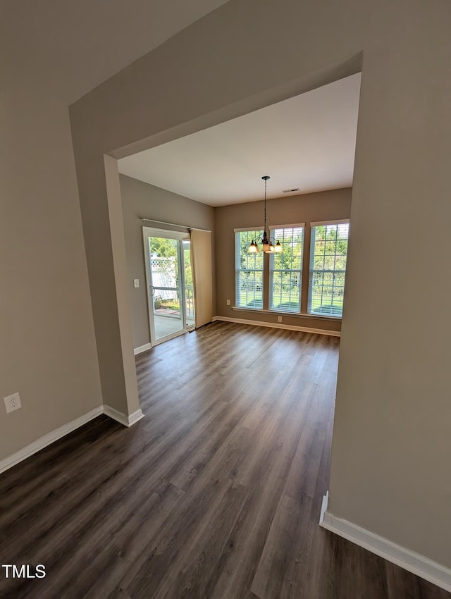 4221 Del Webb Ave, Cary, NC 27519 - unfurnished room with a chandelier and dark wood-type flooring
