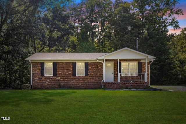 691 Oak Grove Rd, Roxboro, NC 27574 - single story home with a front lawn, brick siding, and a porch