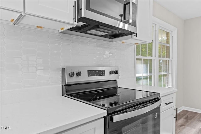 691 Oak Grove Rd, Roxboro, NC 27574 - kitchen featuring stainless steel appliances, white cabinetry, decorative backsplash, and light countertops